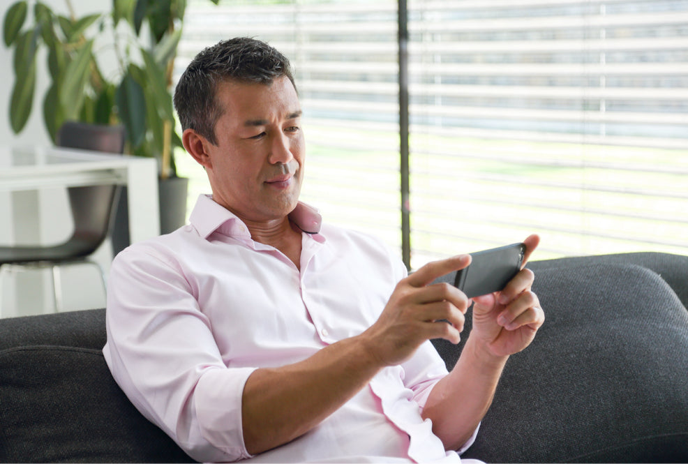 Man on a sofa looking at smartphone 